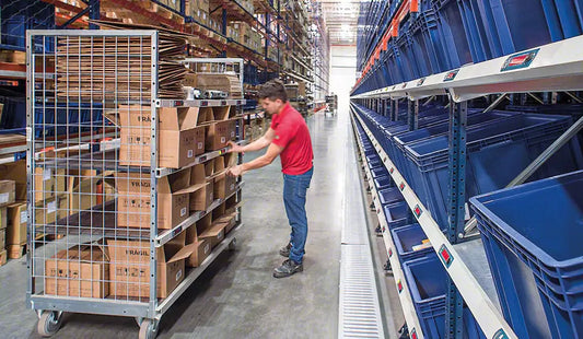 Regały półkowe z paskami LED i lampkami sygnalizacyjnymi wspomagającymi pracowników w kompletacji zamówień w magazynie